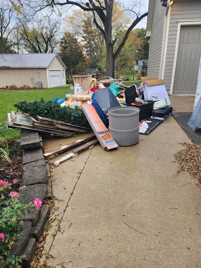 Dumpster being loaded with debris for 12 Yard Dumpster Rental in Grand Mound
